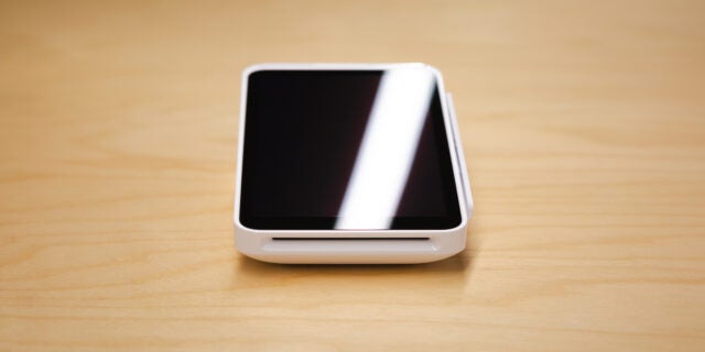 Close-up of Square POS card reader on table. Source: Tech.co