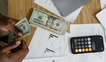 Accounting papers and money with laptop