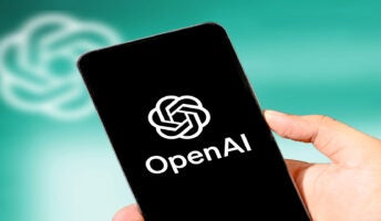Person holding phone with OpenAI on screen