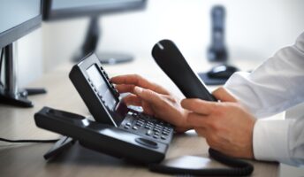 Office worker using desk phone