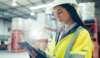 Warehouse supervisor in hardhat and hi-vis