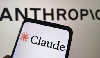 Anthropic logo on a wall, with Claude logo on a phone