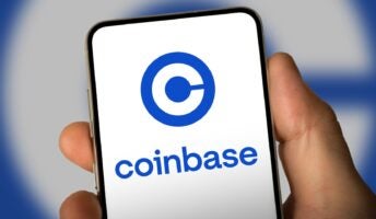 Person holding phone with Coinbase logo